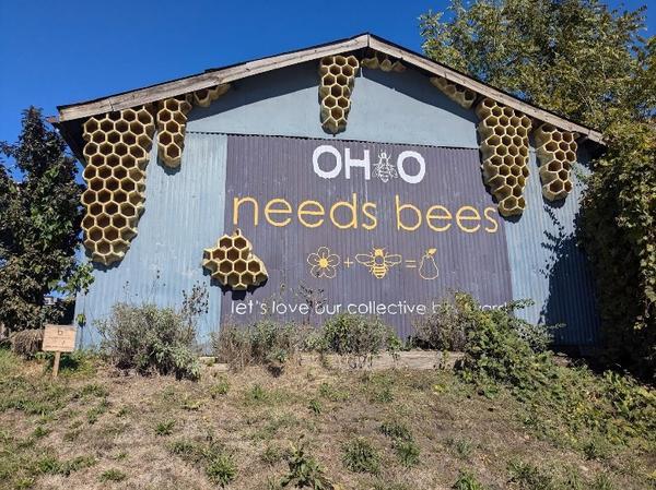 A picture of a shed with a large sign saying Ohio needs bees