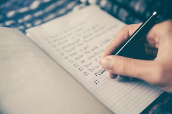a handwritten list with empty checkboxes