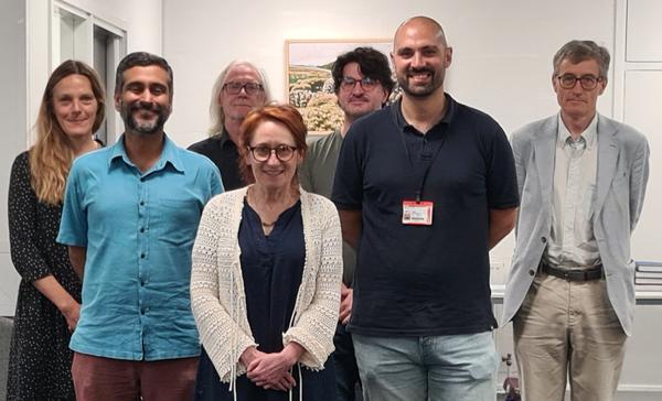 A group of seven people smiling at the camera