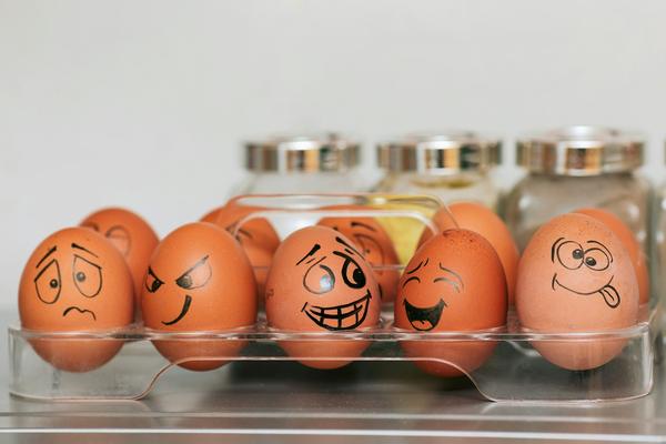 a row of five eggs with faces emoting drawn in