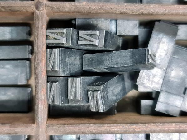 a few pieces of metal type with the letter n